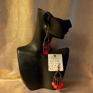 Brass colored dangling earrings with red circle beads and red jewels